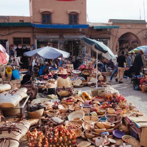 Market and People in Medina, Marrakech. These street markets are famous for a big offering of handmade products, dry fruits and spices.